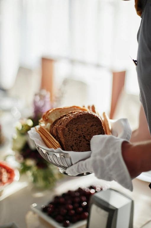 Catering spread with fresh-baked breads and sandwiches