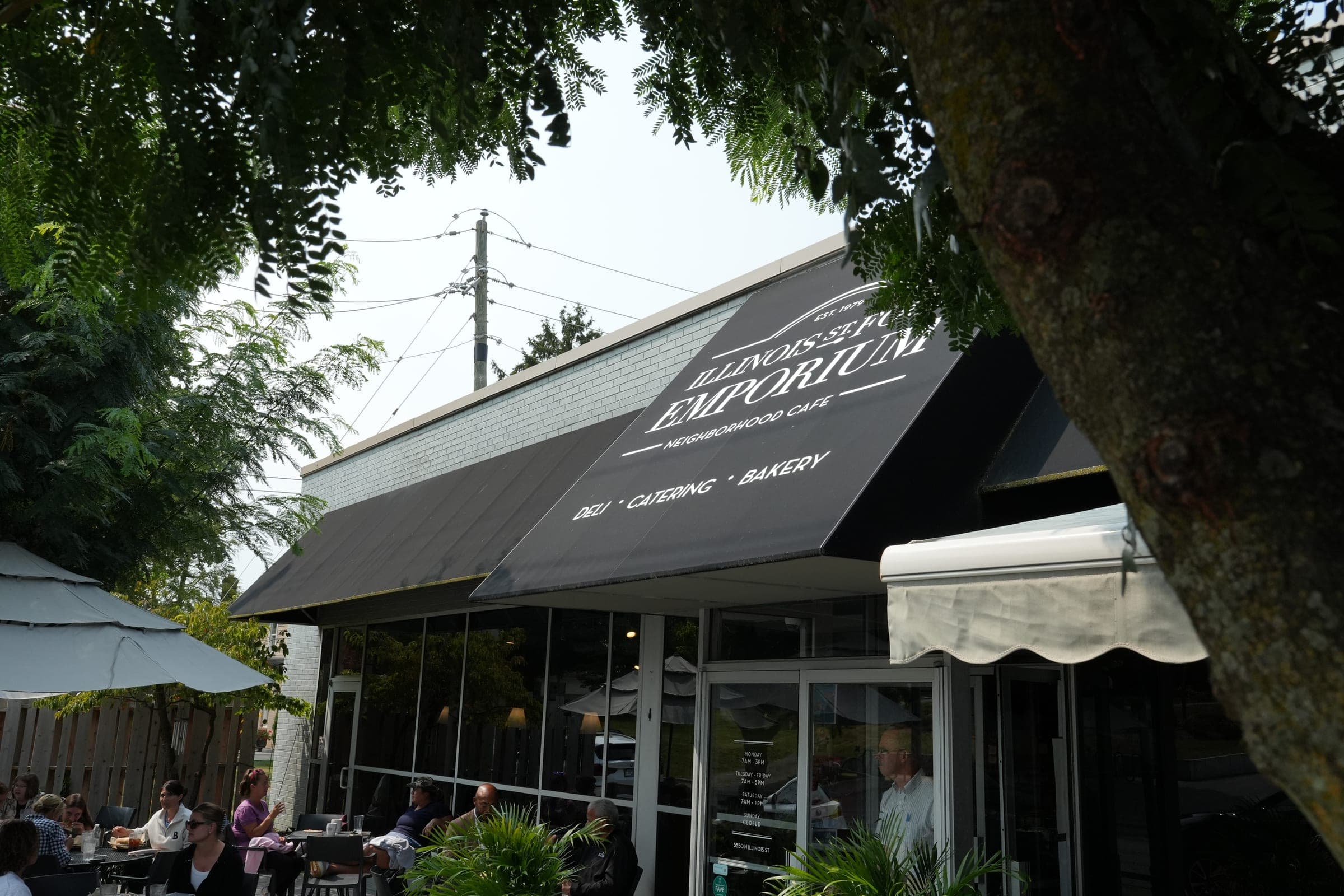 The Illinois Street Food Emporium storefront awning and shaded patio on North Illinois Street
