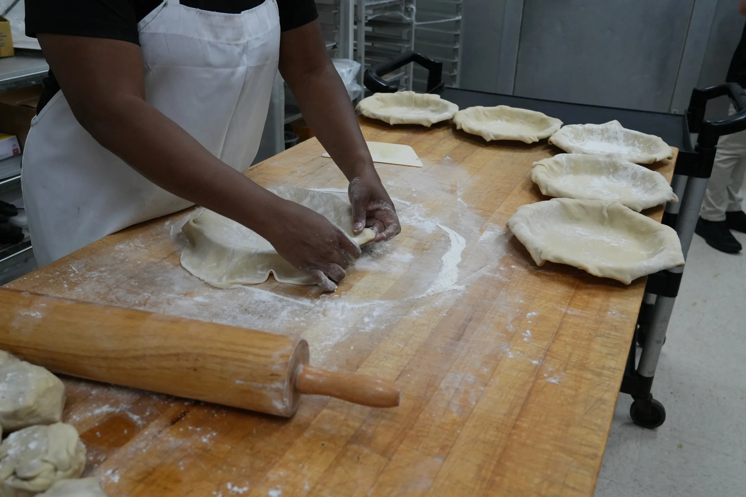 Rolling pie crusts by hand in the Illinois Street Food Emporium bakery